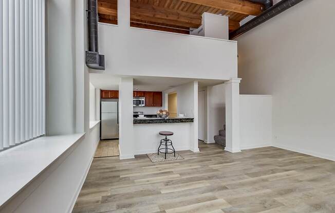 A modern kitchen with a bar stool and a countertop at Lowertown Commons Apartments, St. Paul, MN, 55101