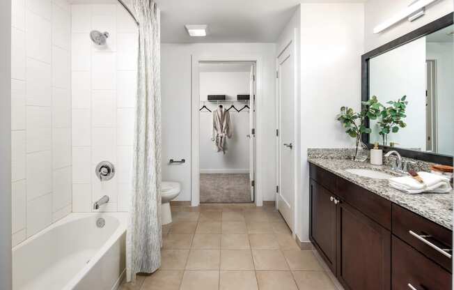 a bathroom with a tub and a shower and a sink