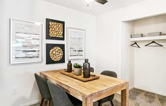A dining room with a wooden table and chairs.