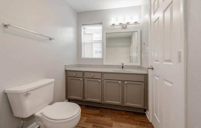A white toilet sits next to a sink in a small bathroom.