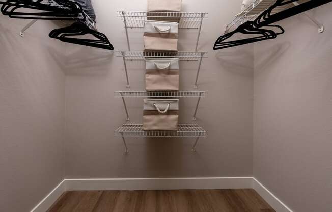 a closet with a rack with bags and shoes in it