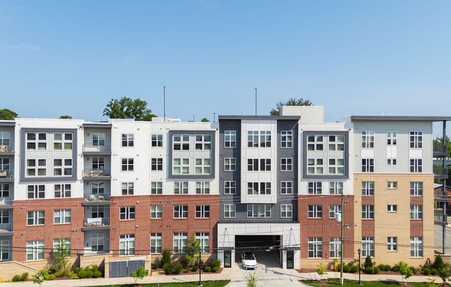 A large multi-story building with a mix of brick and white exterior walls.