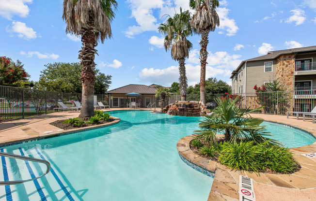 our apartments have a large swimming pool with palm trees
