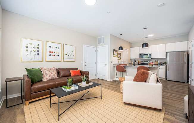 A living room with a brown couch and a white couch.