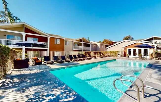A swimming pool surrounded by sun loungers.