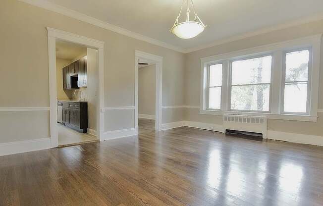A room with wooden floors and a white ceiling with a light fixture.