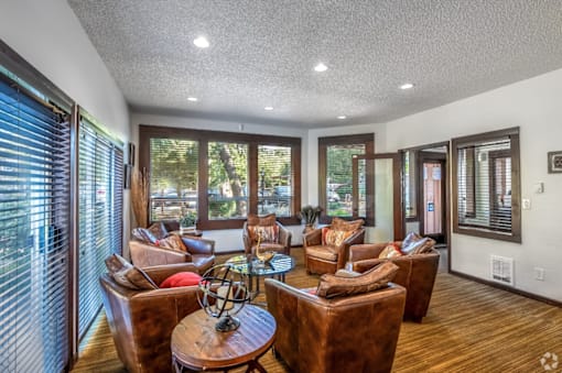 a living room with couches and chairs and a table