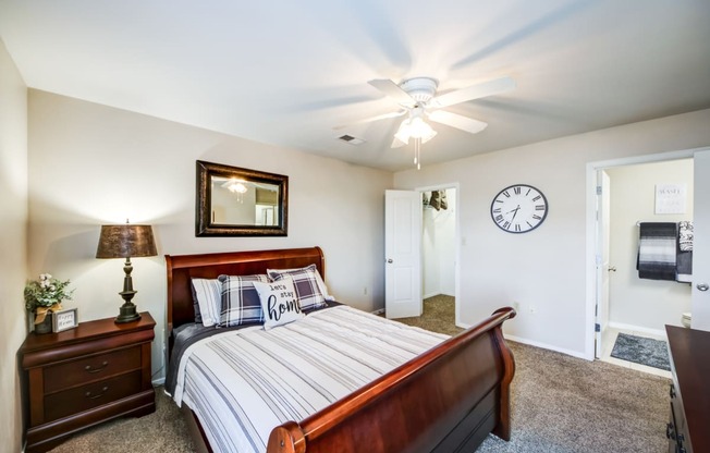 a bedroom with a bed and a ceiling fan