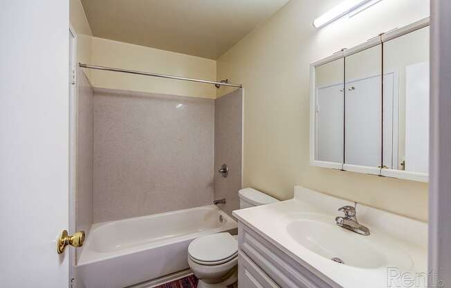 a bathroom with a bathtub toilet and sink at Terrace View Apartments, Daly City