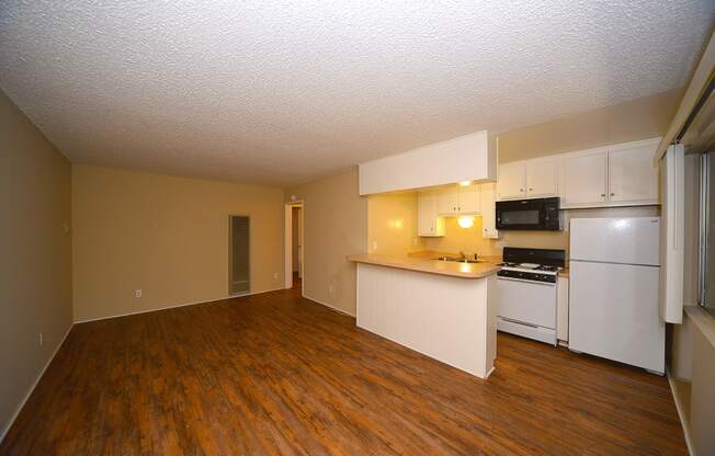 Ponderosa Apartments unfurnished living area with kitchen countertop