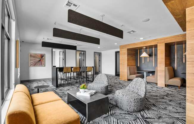a large living room with a black and white patterned carpet