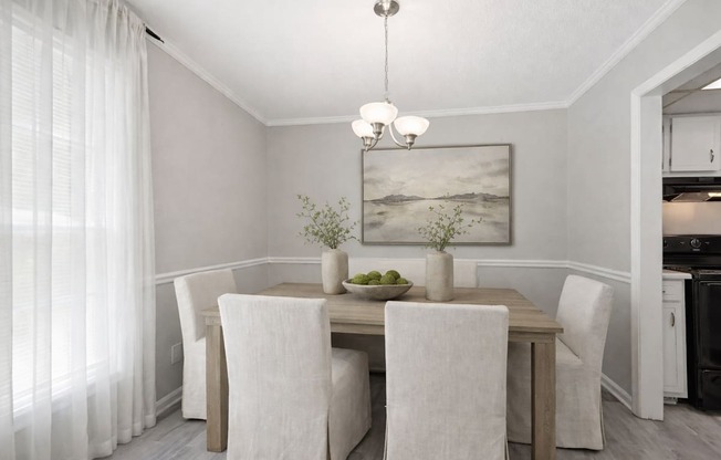 A dining room with a table set for two.