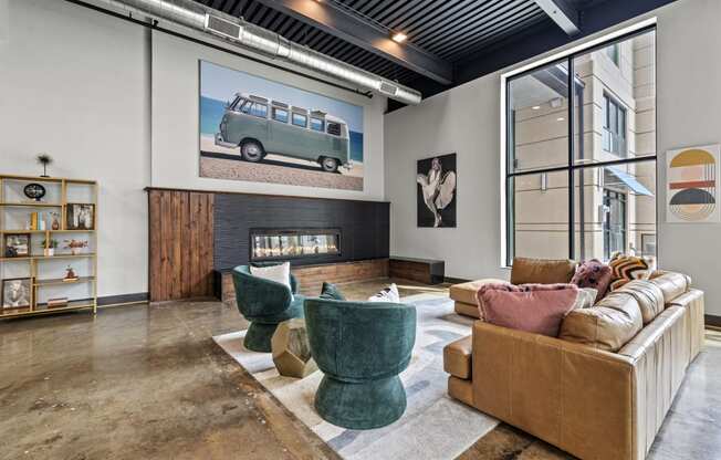 a living room with a fireplace and a large picture of a van on the wall  at The Icon, Virginia
