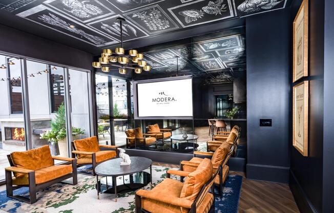 Settle into the lounge at Modera Old Ivy, where layered textures, fireside comfort, and intimate seating create a cinematic escape.