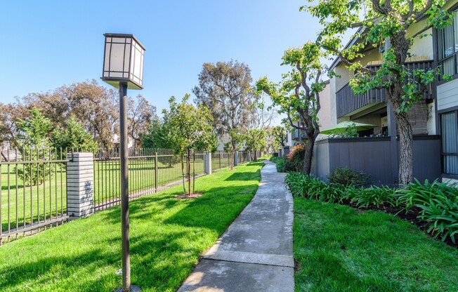 A residential area with a green lawn and a lamp post.