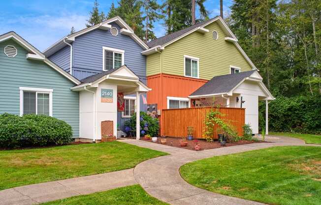 a group of houses with a sidewalk in front of a yard at Woodcreek, Poulsbo, WA 98370