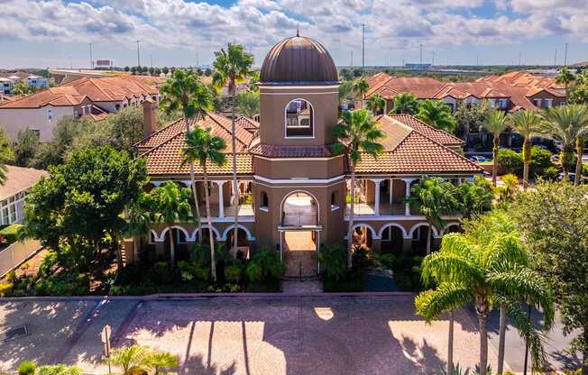 Iconic domed clubhouse surrounded by palm trees and Mediterranean architecture
