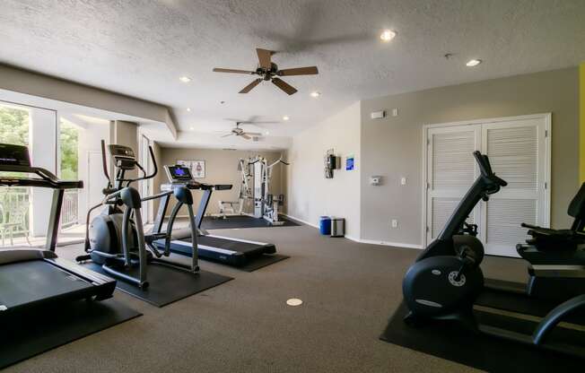 a home gym with treadmills and ellipticals