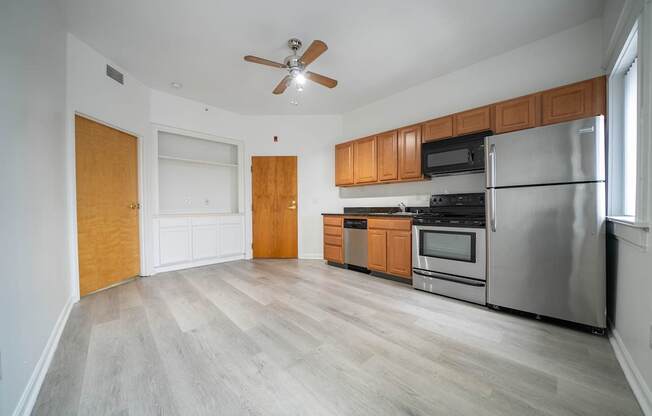 A kitchen with wooden cabinets and stainless steel appliances.