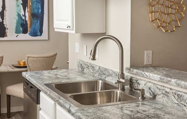 a kitchen with a sink and a faucet at Highland Ridge Apartments, Overland Park , KS