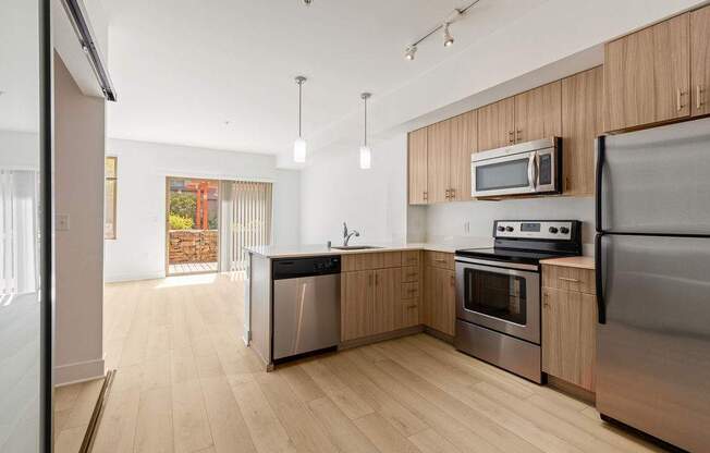 A modern kitchen with wooden cabinets and stainless steel appliances.