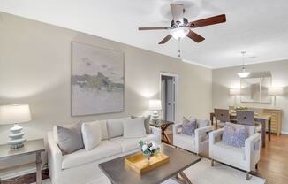 a living room with a ceiling fan and a couch