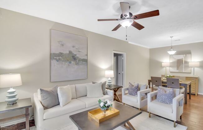 a living room with a ceiling fan and a couch