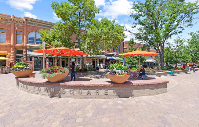 A roundabout with a sign that says "Old Town Square" in the middle.