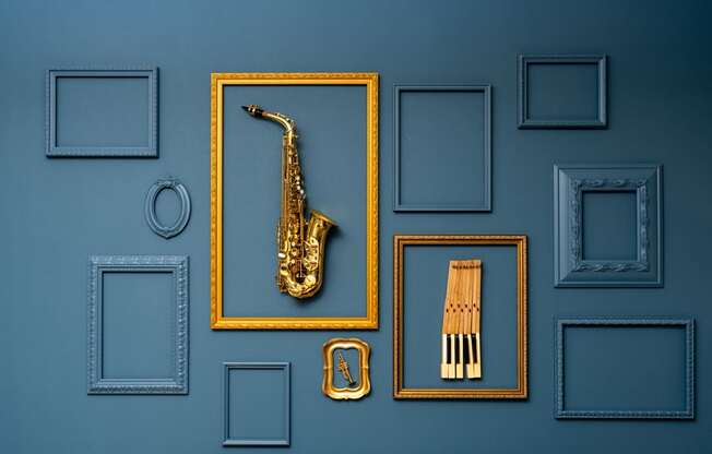 A golden saxophone is in the center of a collection of picture frames.