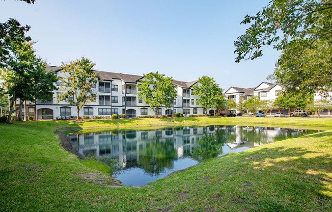 a large pond in front of an apartment building