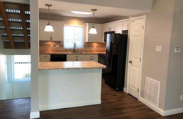 a kitchen with an island in the middle of it