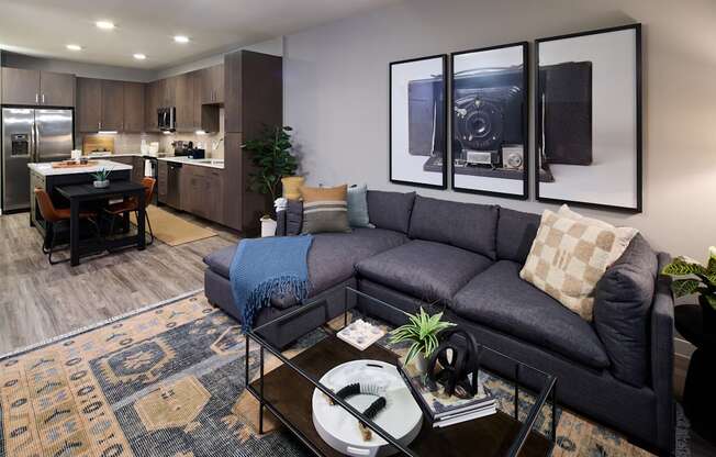 A modern living room with a grey couch and a coffee table.