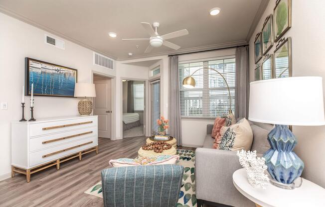 a living room filled with furniture and a large window