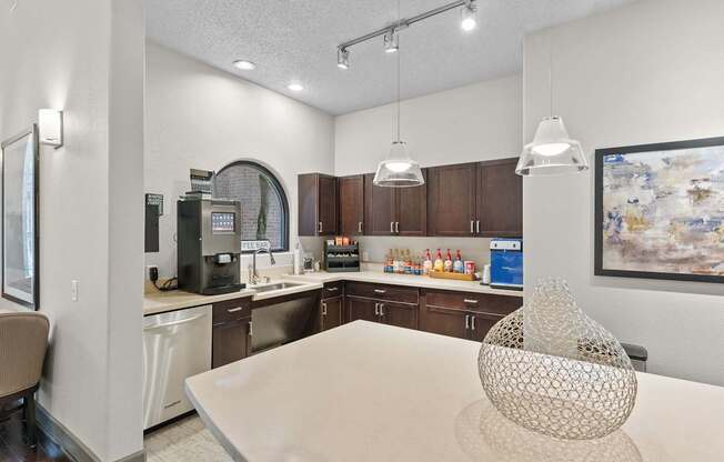 A modern kitchen with a dining table and a coffee machine.