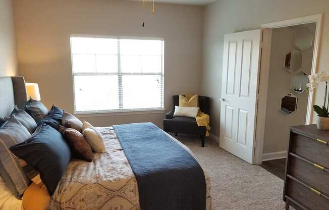 a bedroom with a bed and a chair