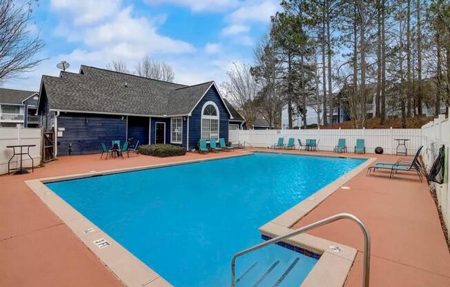 a swimming pool with a house in the background at The Sapphire, Decatur, Georgia