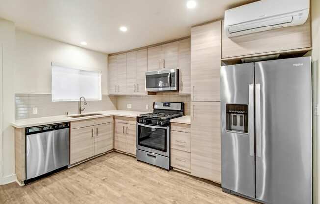 a kitchen with stainless steel appliances and a refrigerator