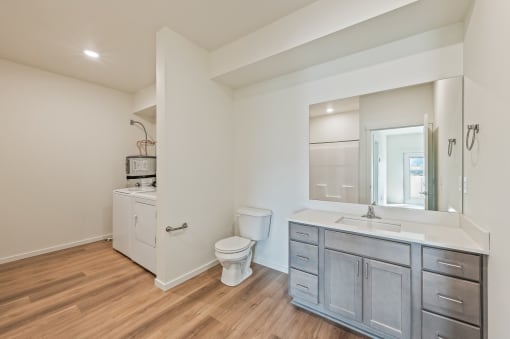 a bathroom with a sink toilet and a mirror at Gateway Apartments, East Wenatchee 