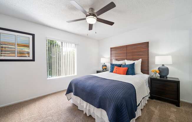 a bedroom with a large bed and a ceiling fan