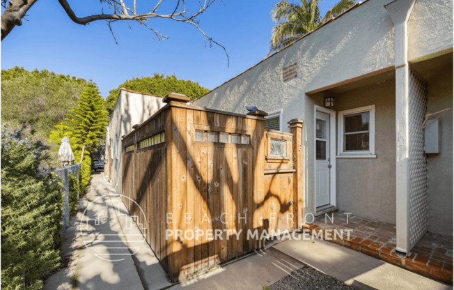 a large wooden gate in front of a house