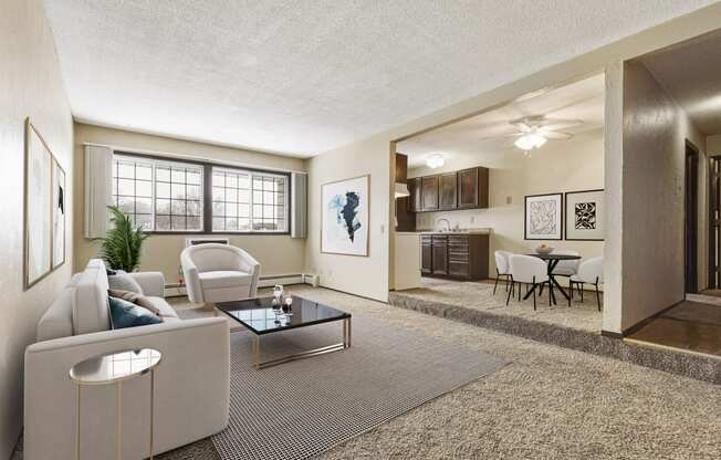 Georgetown on the River Apartments, Fridley, MN, 55432 a living room with a couch table and chairs and a kitchen in the background