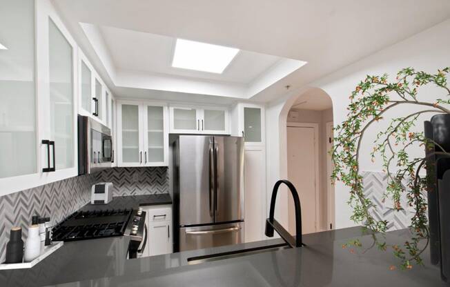 a kitchen with a stainless steel refrigerator and a counter top