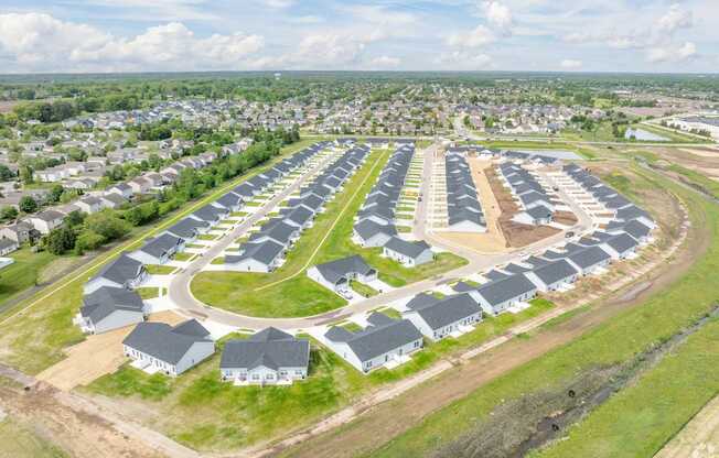 A large housing development with rows of houses and apartment buildings.