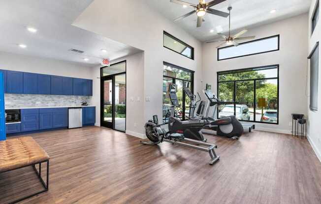 a gym with a reformer exercise bike and a window