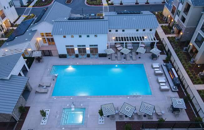 Drone View of Pool at Night with Apartment Exteriors at Morgan Ranch Apartments, Morgan Hill, CA