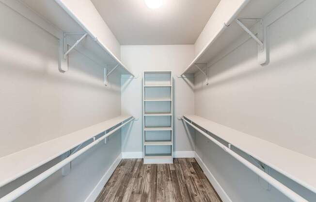 A long white shelf with a blue shelf in the middle.