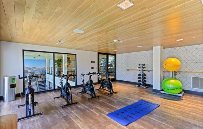 Home gym with exercise bikes and a yoga mat at Array La Mesa, California, 91942