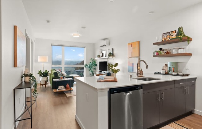 A modern kitchen with a large island and stainless steel appliances.