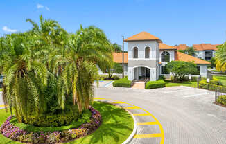 A large house with a red roof and a driveway with a yellow line.