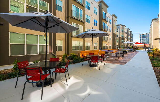 a large patio with tables and chairs and umbrellas at Mockingbird Flats, Texas